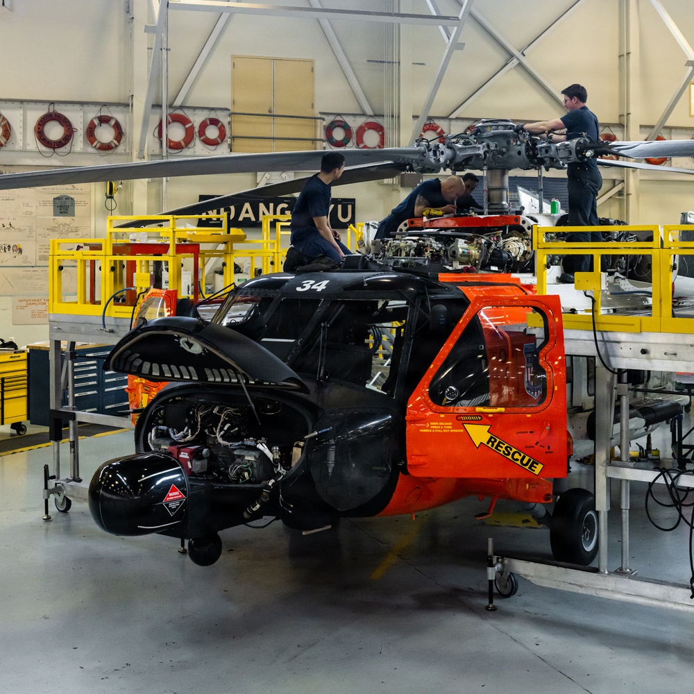 Coast Guard aircraft maintainers conduct maintenance on helicopter in Kodiak, Alaska