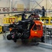 Coast Guard aircraft maintainers conduct maintenance on helicopter in Kodiak, Alaska