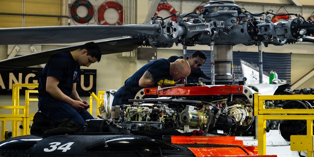 Coast Guard aircraft maintainers conduct maintenance on helicopter in Kodiak, Alaska