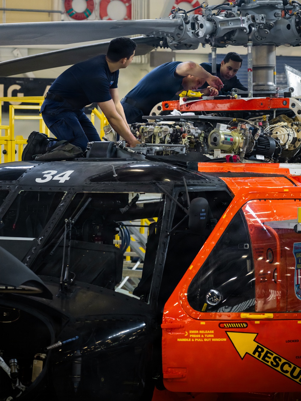 Coast Guard aircraft maintainers conduct maintenance on helicopter in Kodiak, Alaska