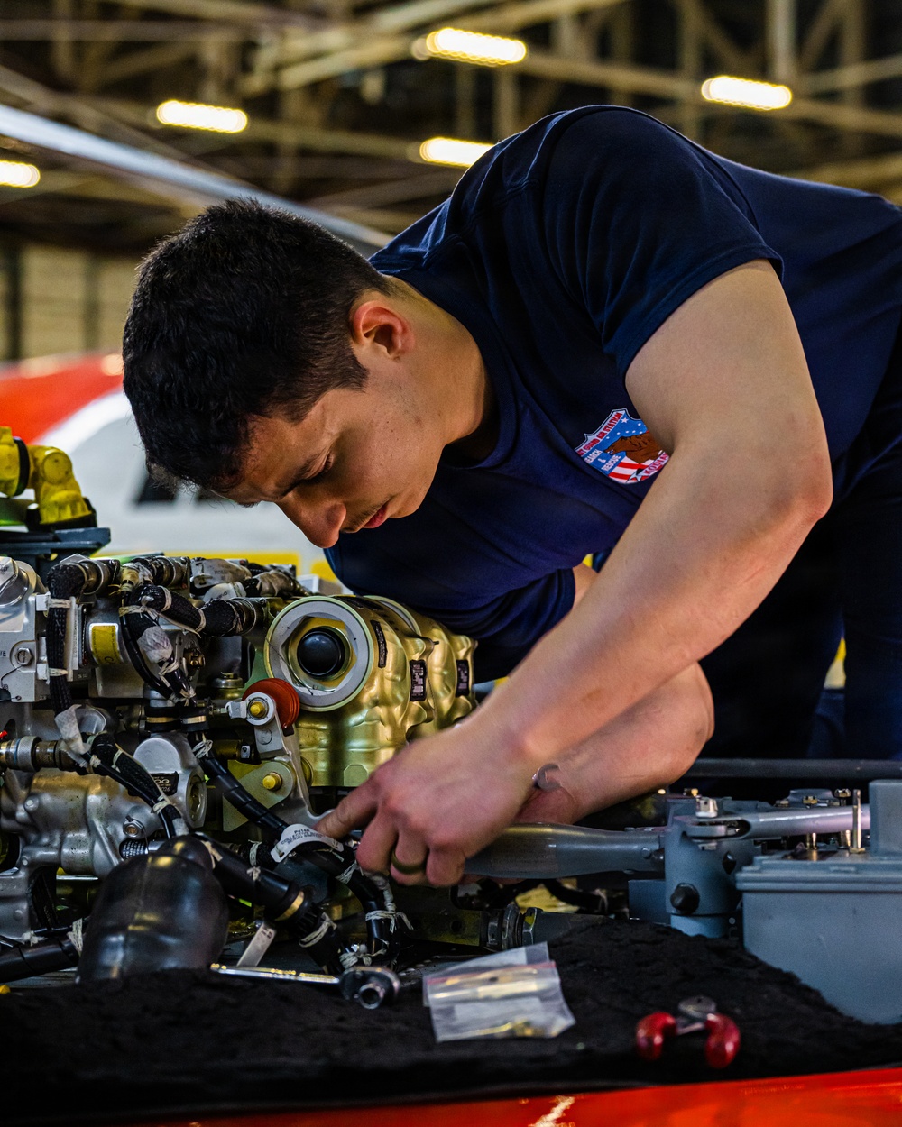 Coast Guard aircraft maintainers conduct maintenance on helicopter in Kodiak, Alaska