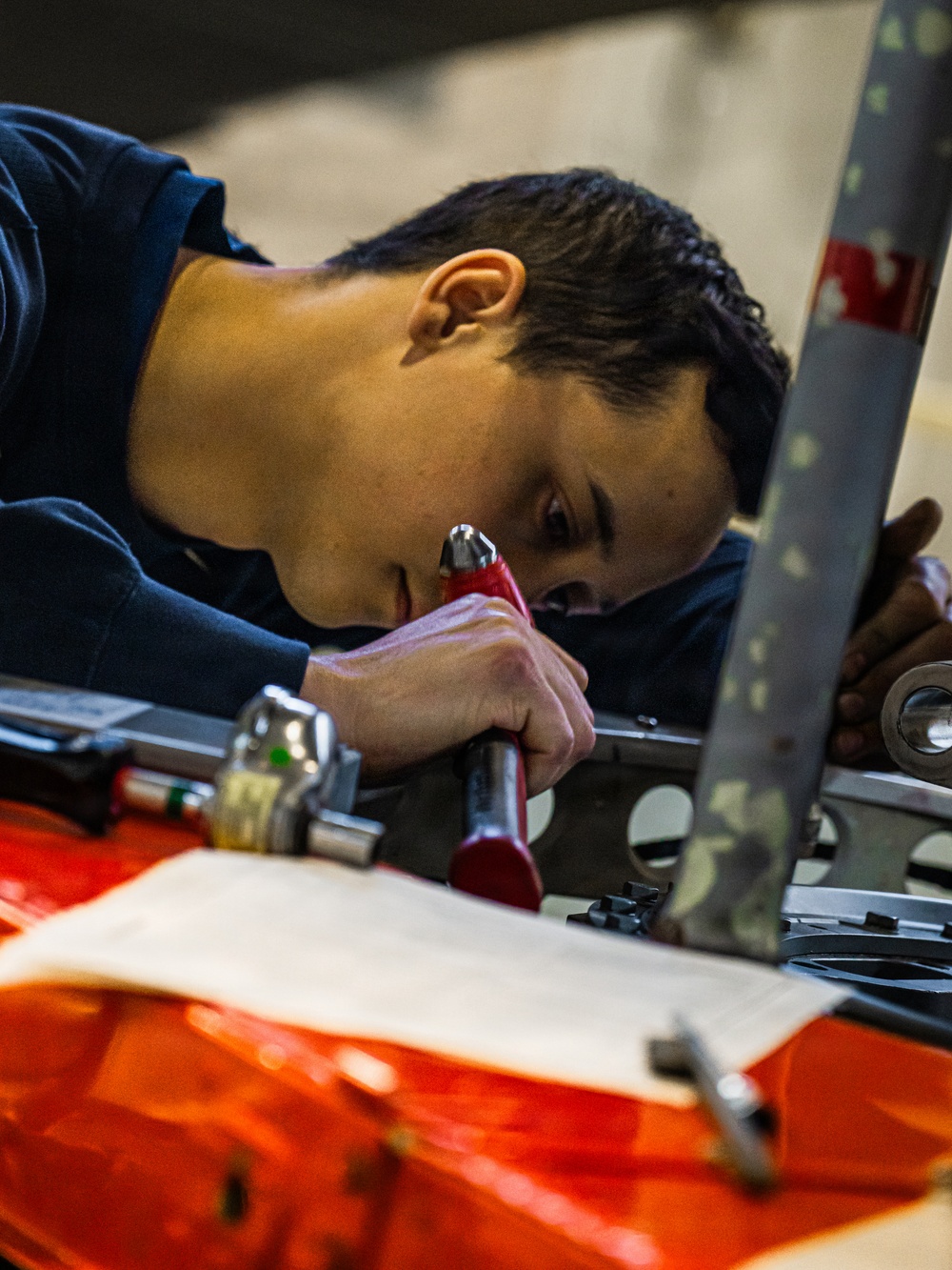Coast Guard aircraft maintainers conduct maintenance on helicopter in Kodiak, Alaska