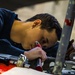Coast Guard aircraft maintainers conduct maintenance on helicopter in Kodiak, Alaska