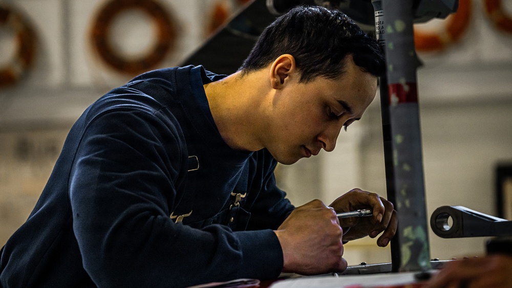 Coast Guard aircraft maintainers conduct maintenance on helicopter in Kodiak, Alaska