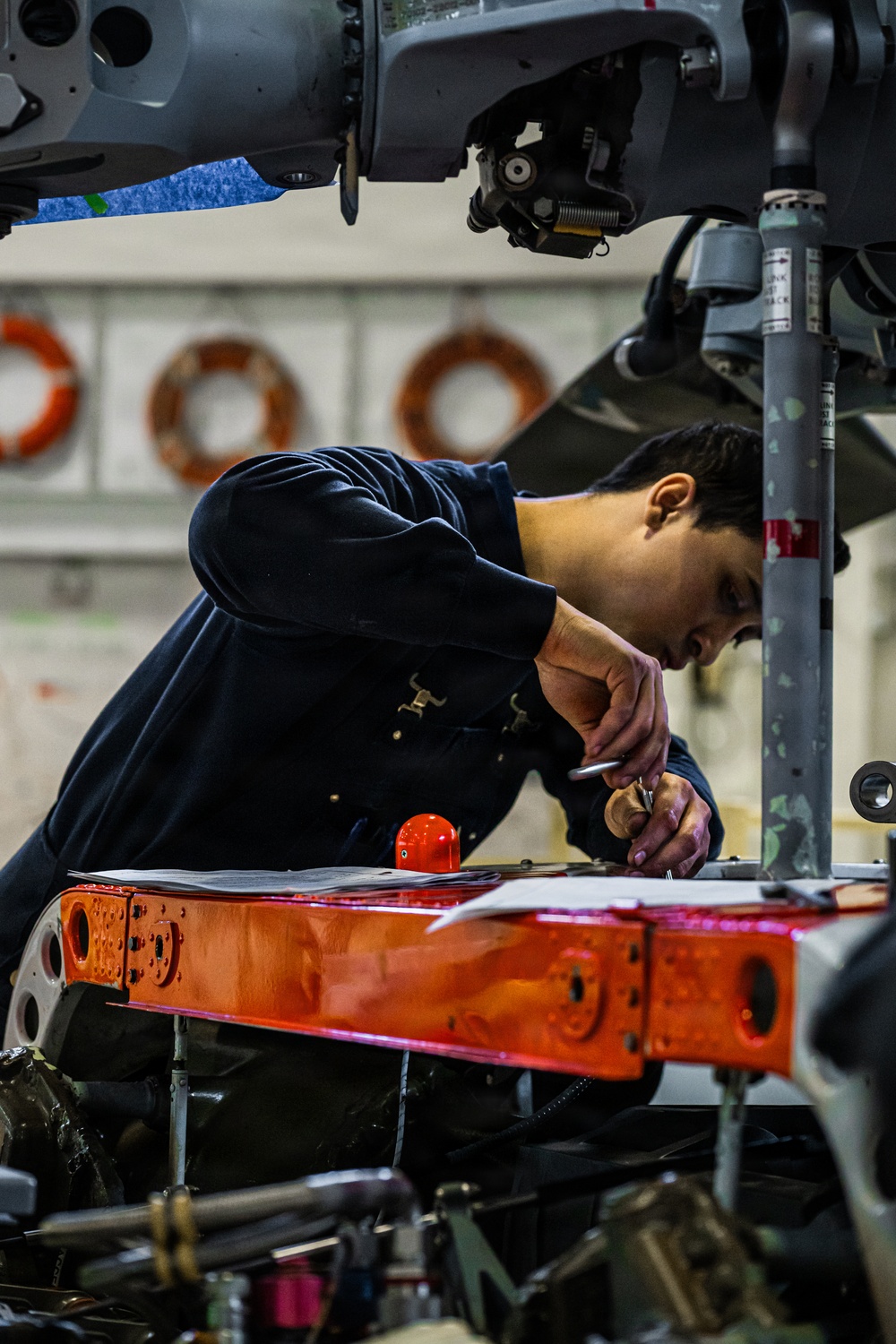 Coast Guard aircraft maintainers conduct maintenance on helicopter in Kodiak, Alaska
