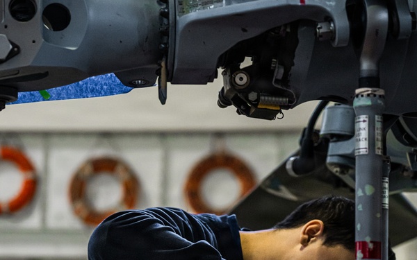 Coast Guard aircraft maintainers conduct maintenance on helicopter in Kodiak, Alaska