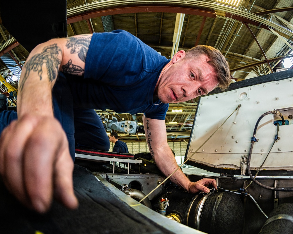 Coast Guard aircraft maintainers conduct maintenance on helicopter in Kodiak, Alaska