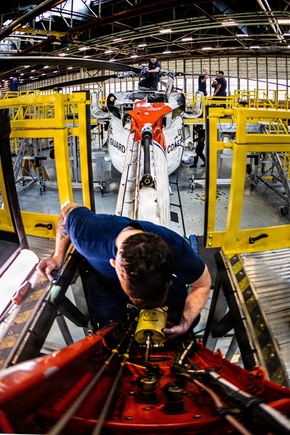Coast Guard aircraft maintainers conduct maintenance on helicopter in Kodiak, Alaska