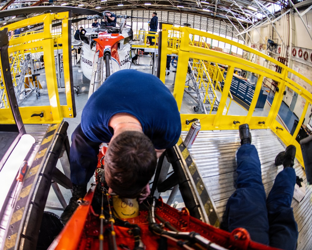 Coast Guard aircraft maintainers conduct maintenance on helicopter in Kodiak, Alaska