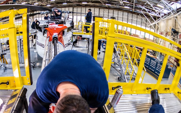 Coast Guard aircraft maintainers conduct maintenance on helicopter in Kodiak, Alaska