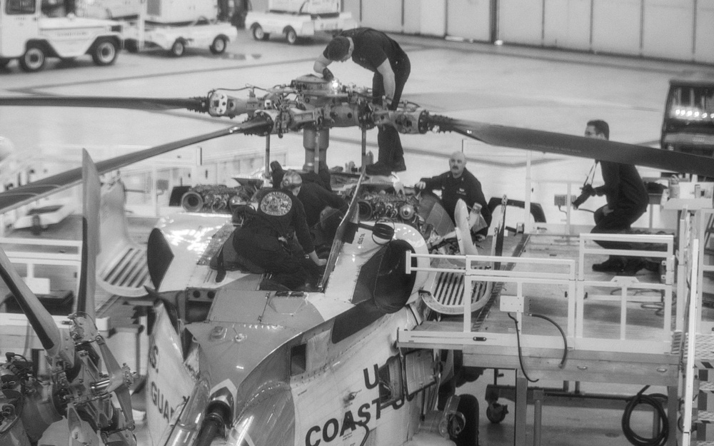 Coast Guard aircraft maintainers conduct maintenance on helicopter in Kodiak, Alaska