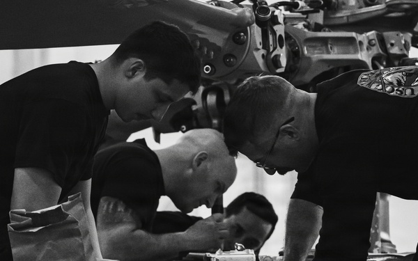 Coast Guard aircraft maintainers conduct maintenance on helicopter in Kodiak, Alaska