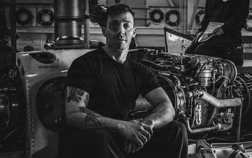 Coast Guard Air Station Kodiak maintainers sit for portraits during maintenance operations
