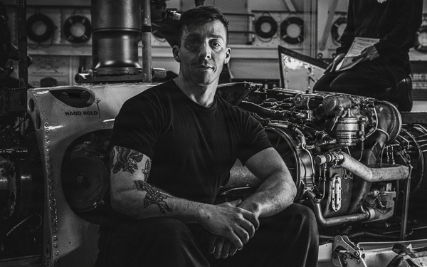 Coast Guard Air Station Kodiak maintainers sit for portraits during maintenance operations