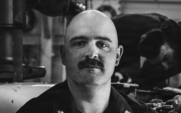 Coast Guard Air Station Kodiak maintainers sit for portraits during maintenance operations