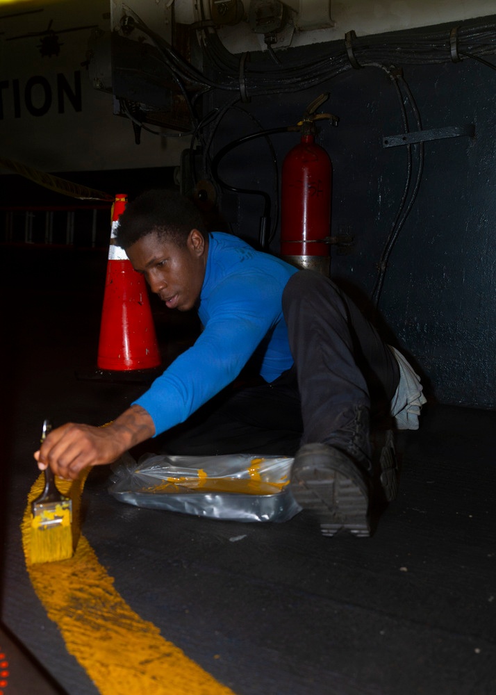 Nimitz Sailor Paints the Deck of the Hangar Bay