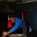 Nimitz Sailor Paints the Deck of the Hangar Bay