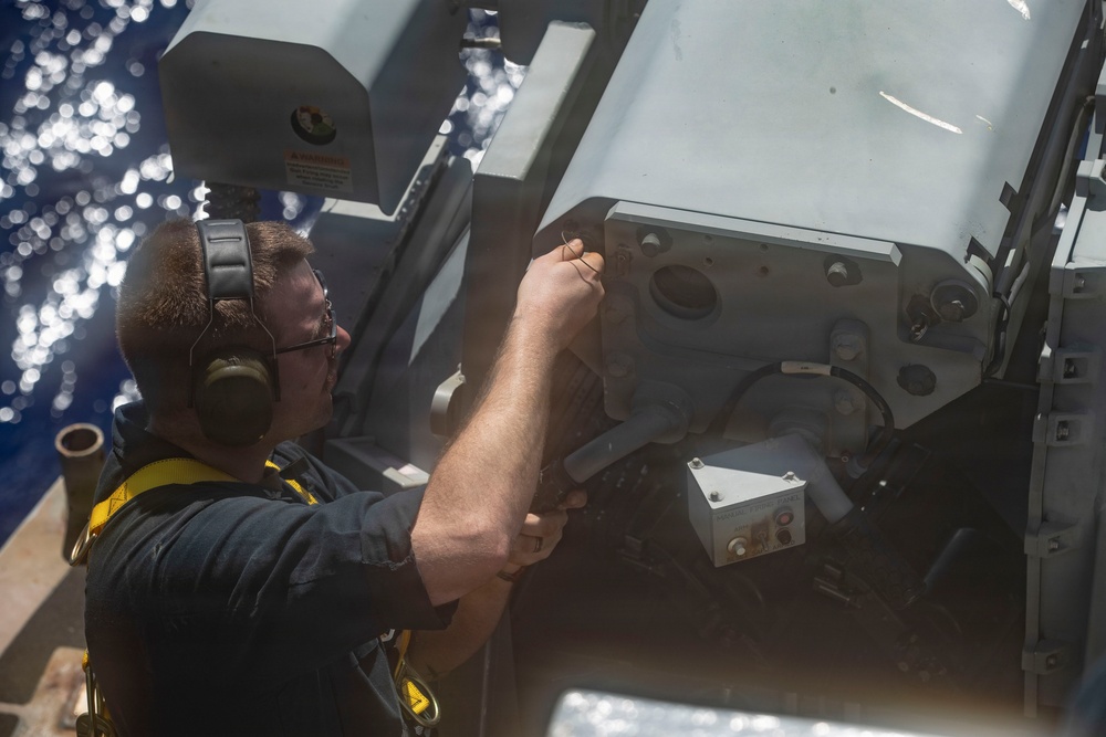 George Washington Sailors fire a MK 38 Machine Gun
