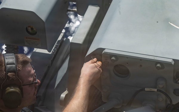 George Washington Sailors fire a MK 38 Machine Gun