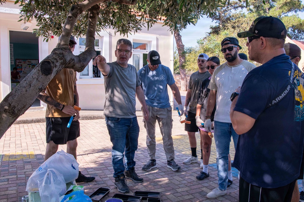 NSA Souda Bay Sailors paint a local elementary school
