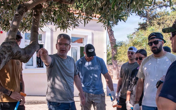 NSA Souda Bay Sailors paint a local elementary school