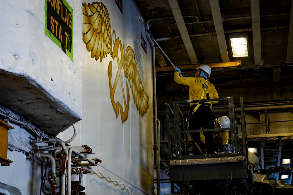 USS Iwo Jima Sailor Paints the Hangar Bay