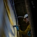 USS Iwo Jima Sailor Paints the Hangar Bay