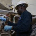 USS Iwo Jima Sailor Maintains Pipes
