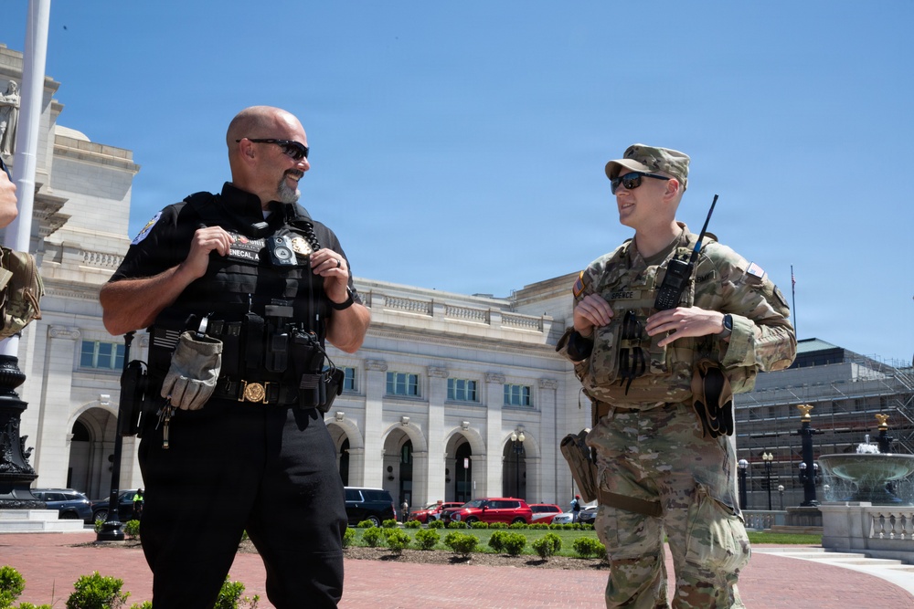 West Virginia National Guardsman Speaks to Police Officer At Columbus Circle