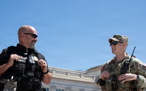 West Virginia National Guardsman Speaks to Police Officer At Columbus Circle