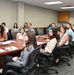 PALACE Acquire program graduates watch a slideshow brief