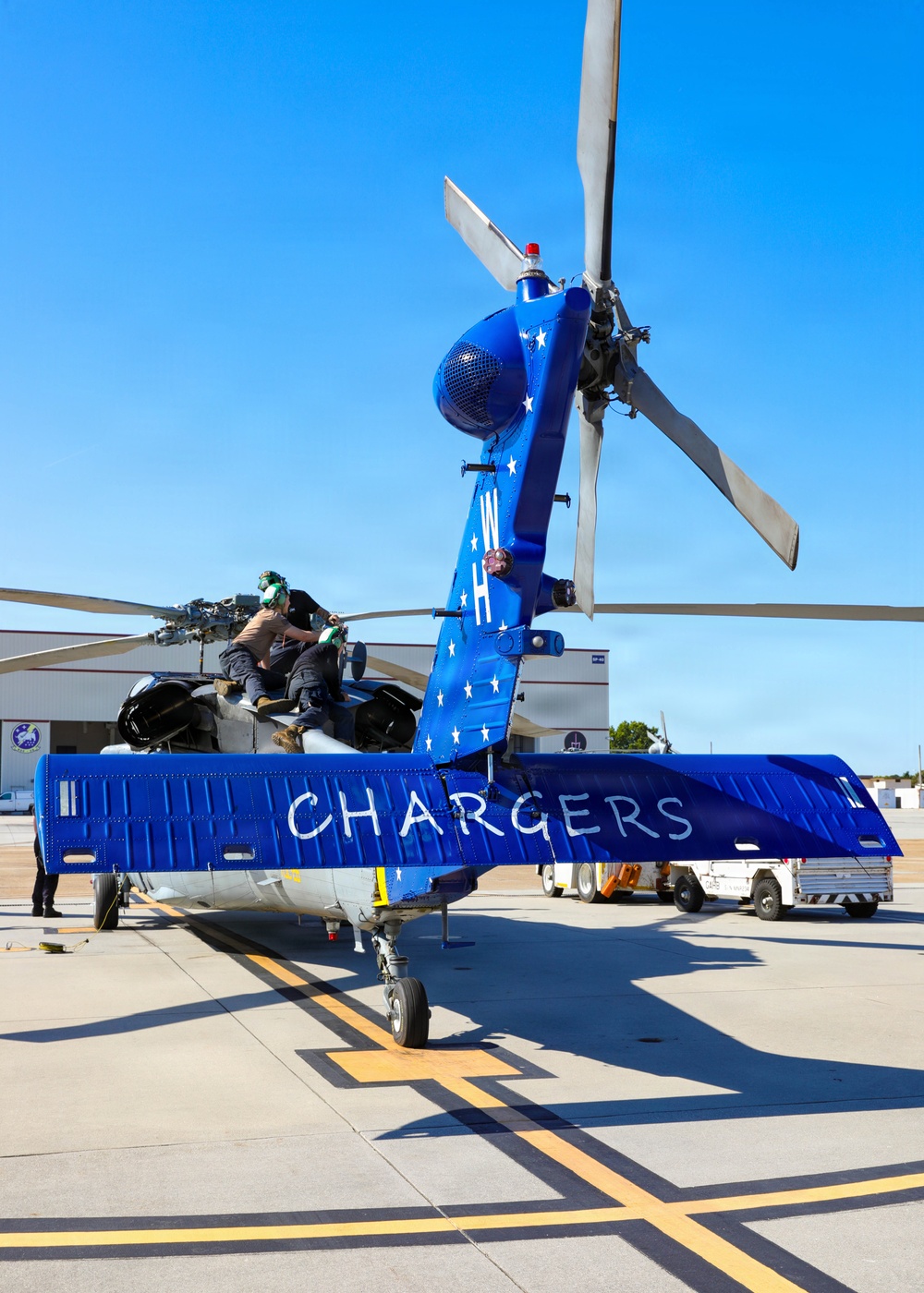 HSC-26 finish painting the tail of their MH-60S Seahawk helicopter