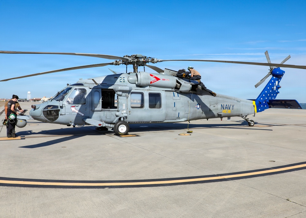 HSC-26 finish painting the tail of their MH-60S Seahawk helicopter