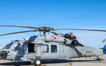 HSC-26 finish painting the tail of their MH-60S Seahawk helicopter