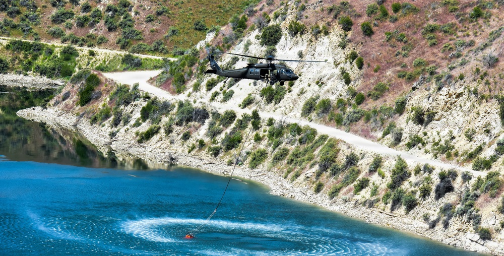 Idaho Army National Guard UH-60M Black Hawk helicopter crew conducts water bucket training.