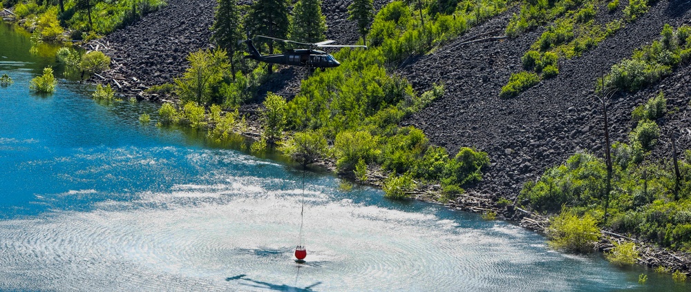 Idaho Army National Guard UH-60M Black Hawk helicopter crew conducts water bucket training.