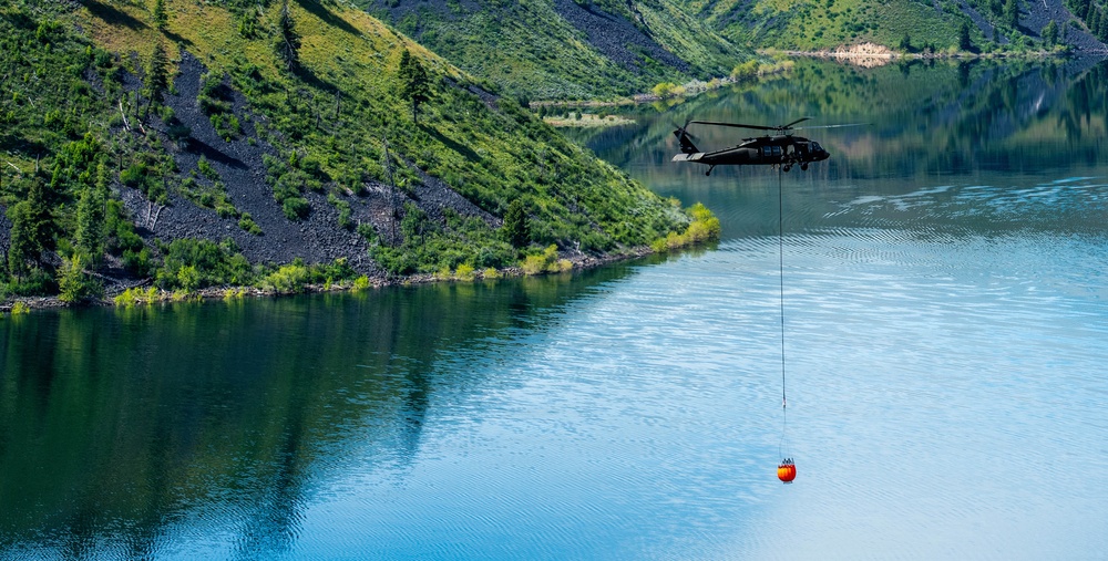 Idaho Army National Guard UH-60M Black Hawk helicopter crew conducts water bucket training.