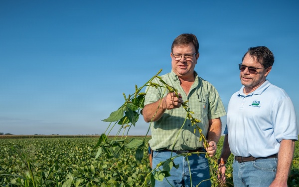 Soybean farmer with RMA employee