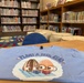 Plant A Seed Read literacy promotion T-shirt displayed in school library
