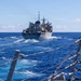 USS Mustin conducts a replenishment-at-sea with USNS Arctic