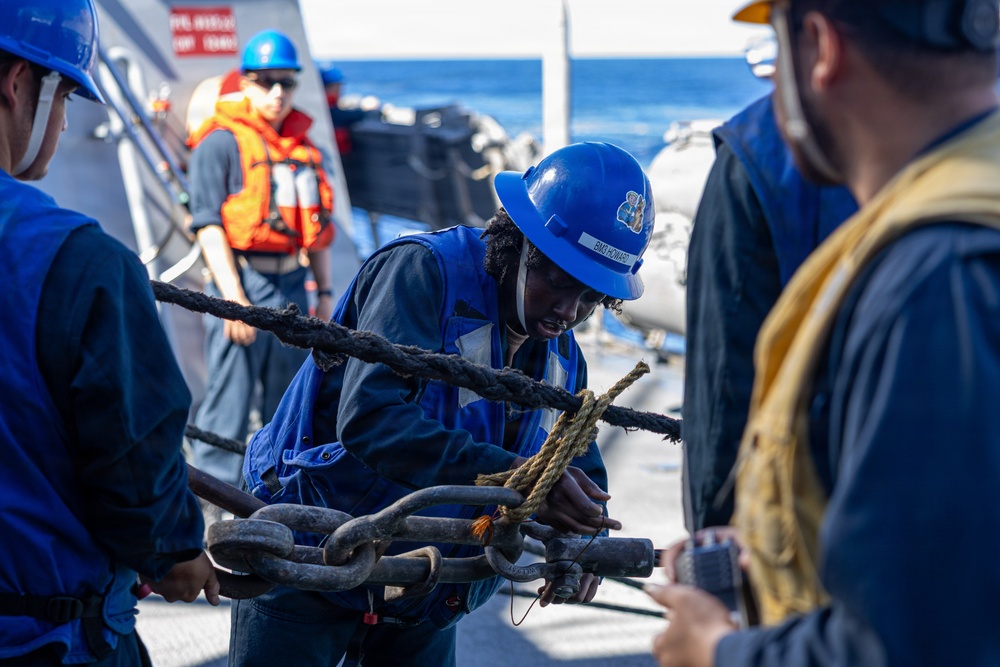 USS Mustin conducts a replenishment-at-sea with USNS Arctic
