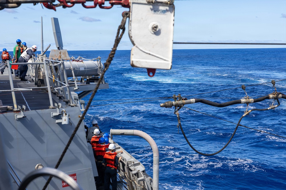 USS Mustin conducts a replenishment-at-sea with USNS Arctic