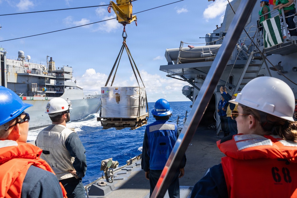 USS Mustin conducts a replenishment-at-sea with USNS Arctic