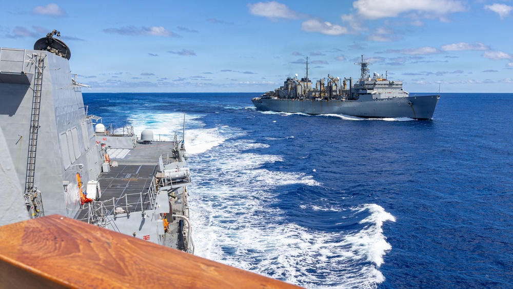 USS Mustin conducts a replenishment-at-sea with USNS Arctic