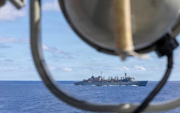 USS Mustin conducts a replenishment-at-sea with USNS Arctic