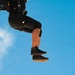 U.S. Army Golden Knights parachutist descends under black and gold canopy during Hyundai Air and Sea Show