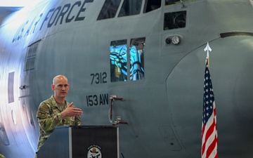 Lt. Col. John Jasper addresses airmen during ceremony at 153rd Airlift Wing hangar