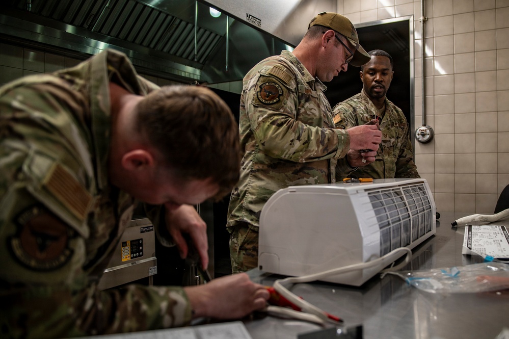 Civil engineers repair air conditioning unit