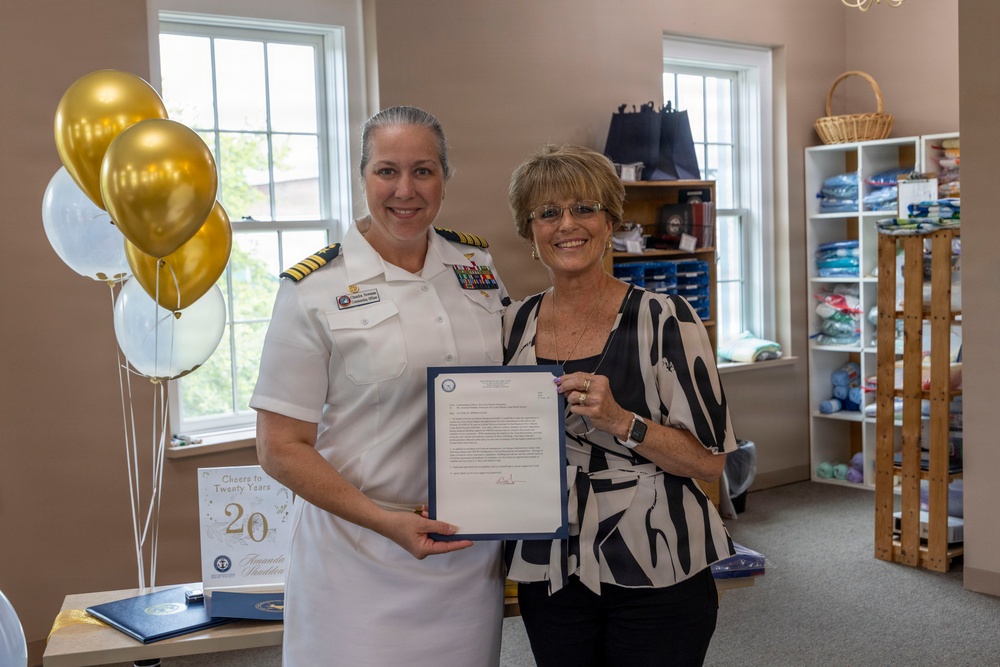 Capt. Chandra "Mamasan" Newman, Naval Air Station (NAS) Pensacola's commanding officer, presents a letter of appreciation to Navy-Marine Corps Relief Society (NMCRS) Relief Services Assistant Amanda Shadden recognizing her 20 years of service, June 5.