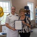 Capt. Chandra "Mamasan" Newman, Naval Air Station (NAS) Pensacola's commanding officer, presents a letter of appreciation to Navy-Marine Corps Relief Society (NMCRS) Relief Services Assistant Amanda Shadden recognizing her 20 years of service, June 5.